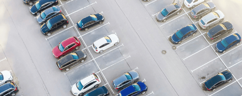 bird's eye view of a parking lot with parked cars