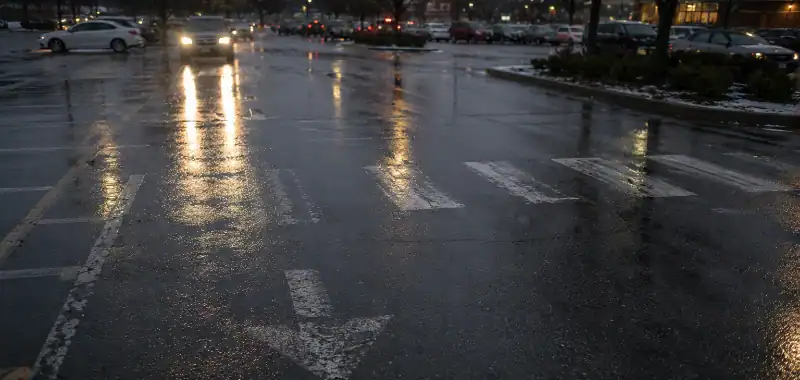 wet parking lot at dusk during rain